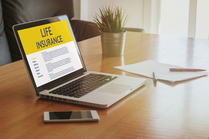 Laptop computer with Life Insurance contract in the screen.